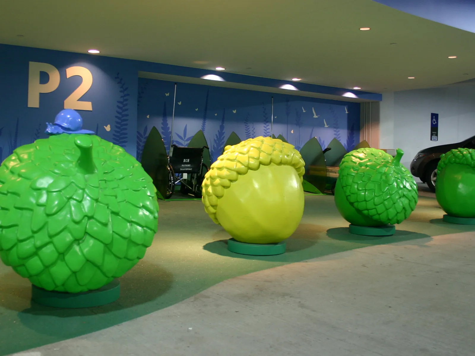 Large green and yellow acorn sculptures front view