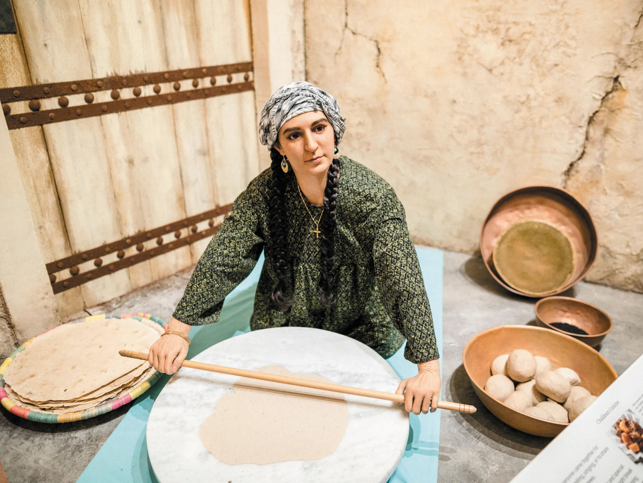 Figure of woman rolling out tortillas at Chaldeans Cultural Center