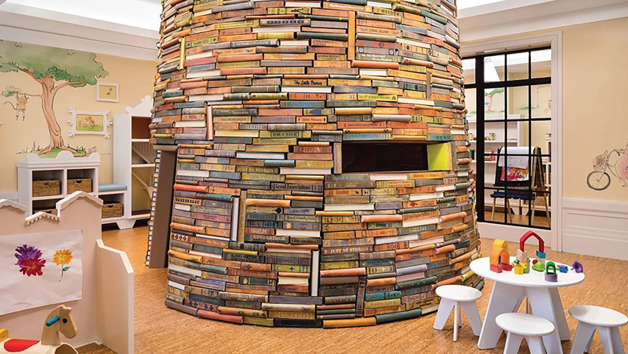 Children's play area with large fort constructed of books