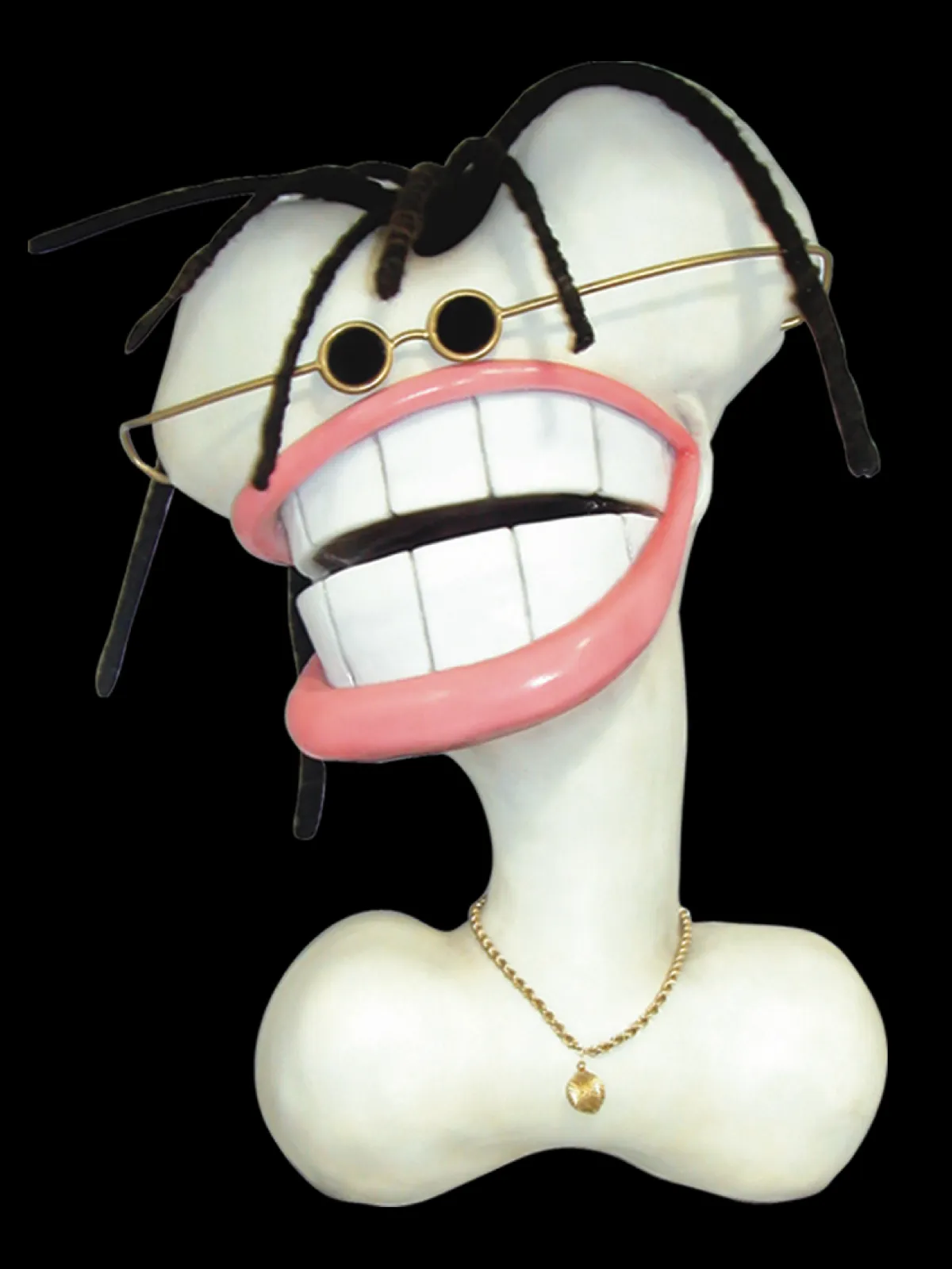 Large bone object with dreadlocks, glasses and smiling teeth