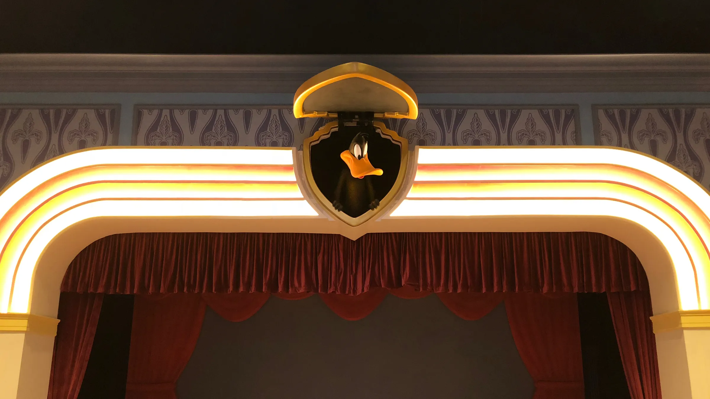 Daffy Duck figure overlooking an archway